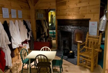 Interior of the Connecticut Museum in Hartford. Showcasing a colonial kitchen complete with table, food and fireplace.