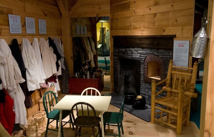 Interior of the Connecticut Museum in Hartford. Showcasing a colonial kitchen complete with table, food and fireplace.