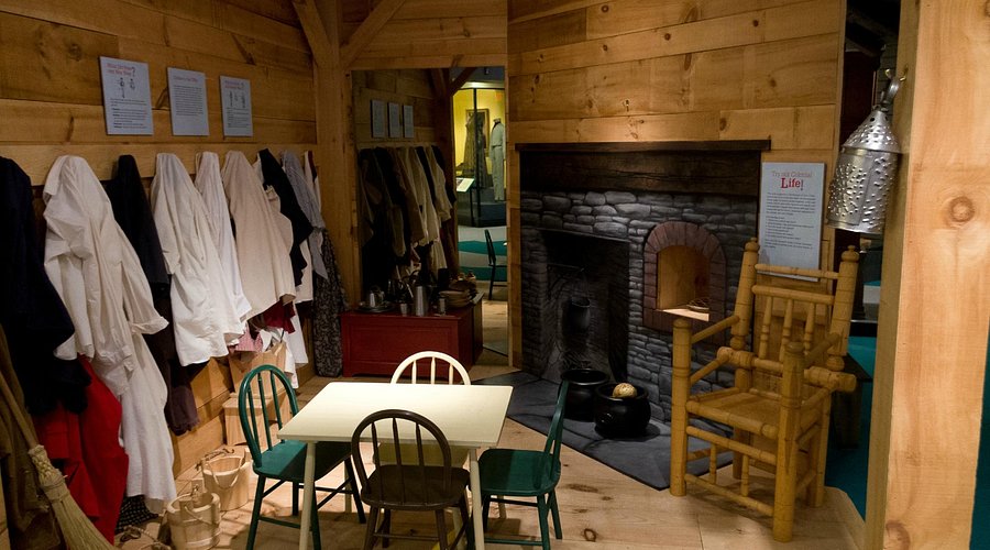Interior of the Connecticut Museum in Hartford. Showcasing a colonial kitchen complete with table, food and fireplace.